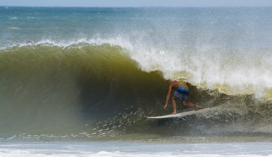 During Tropical Storm Leslie, the outer bar at Oregon Inlet and a shorebreak point appeared that no one could remember ever seeing before. Due to a well timed contest, there was a star studded cast of surfers from the east coast and beyond who were ready to test these new breaks. Tristan Thompson from Florida checks on the inside of a shorebreak barrel.